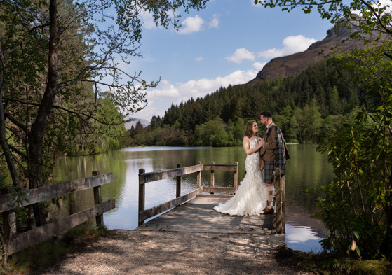 bride and groom on a jetty at glencoe lochan 
